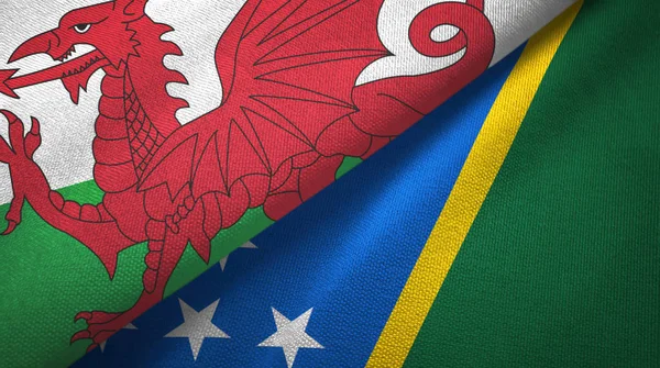 Wales and Solomon Islands two flags textile cloth, fabric texture