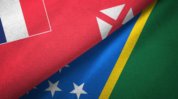 Wallis and Futuna and Solomon Islands two flags textile cloth, fabric texture