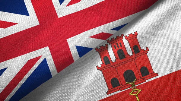 United Kingdom and Gibraltar two flags textile cloth, fabric texture — Stok fotoğraf