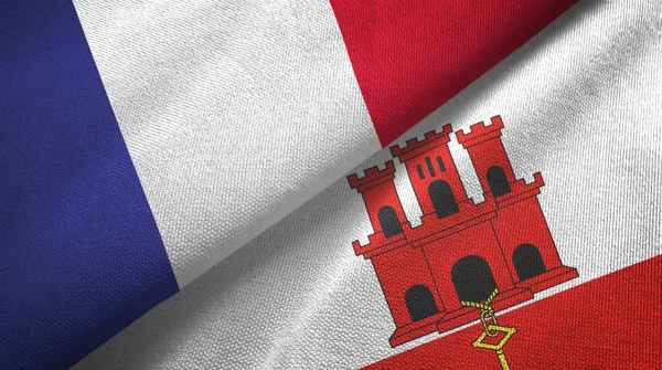 Frankrijk en Gibraltar twee vlaggen textiel doek, stof textuur — Stockfoto