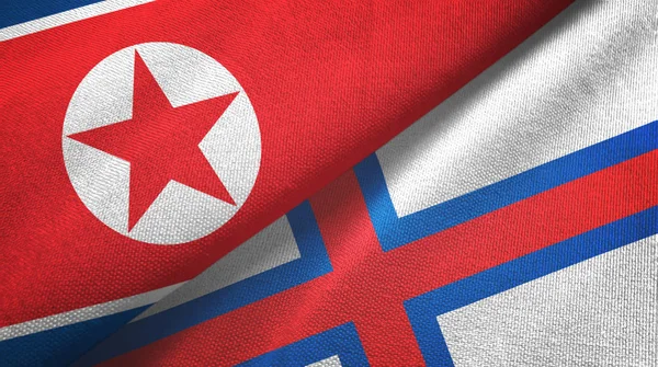 North Korea and Faroe Islands two flags textile cloth, fabric texture — Stock Photo, Image