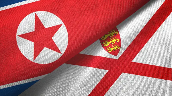 Korea Północna i Jersey dwie flagi tkaniny tekstylne, tekstura tkaniny — Zdjęcie stockowe