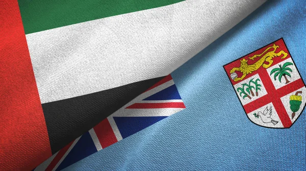 Emiratos Árabes Unidos y Fiji dos banderas tela textil, textura de la tela — Foto de Stock
