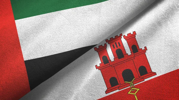 Egyesült Arab Emírségek és Gibraltár két zászló textil ruha, szövet textúra — Stock Fotó