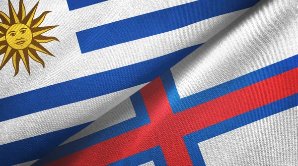 Uruguay e Islas Feroe dos banderas tela textil, textura de la tela —  Fotos de Stock