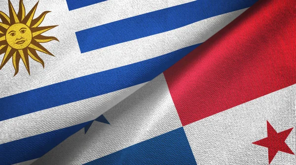Uruguay y Panamá dos banderas de tela textil, textura de tela —  Fotos de Stock