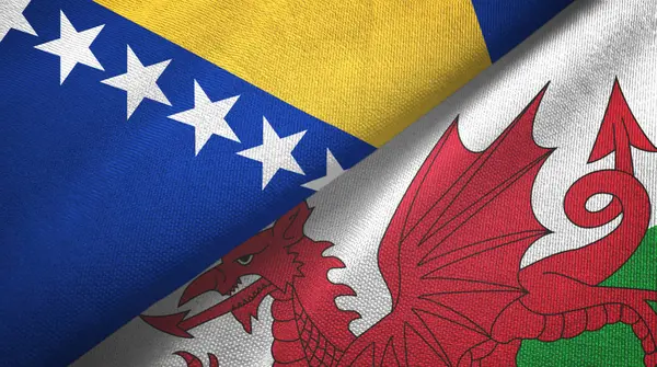 Bosnia y Herzegovina y Gales dos banderas tela textil, textura de la tela — Foto de Stock