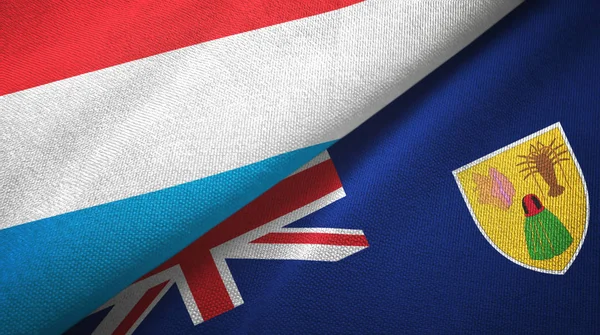 Luxemburgo y las Islas Turcas y Caicos dos banderas tela textil, textura de la tela — Foto de Stock