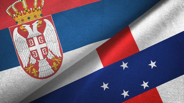 Serbia dan Belanda Antilles dua bendera kain tekstil, tekstur kain — Stok Foto