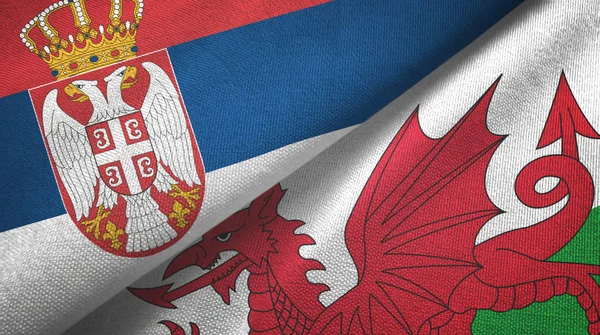 Serbien und Wales zwei Flaggen Textiltuch, Textiltextur — Stockfoto
