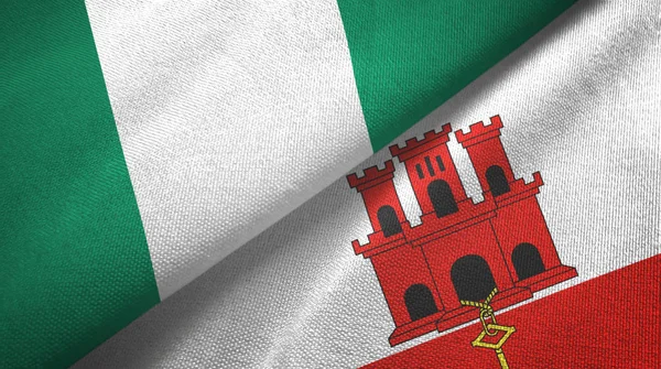 Nigeria y Gibraltar dos banderas tela textil, textura de la tela — Foto de Stock