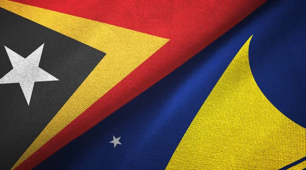 East Timor and Tokelau two flags textile cloth, fabric texture — Stock Photo, Image