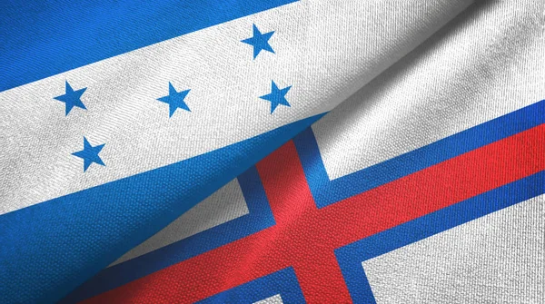 Honduras en de Faeröer twee vlaggen textiel doek, stof textuur — Stockfoto