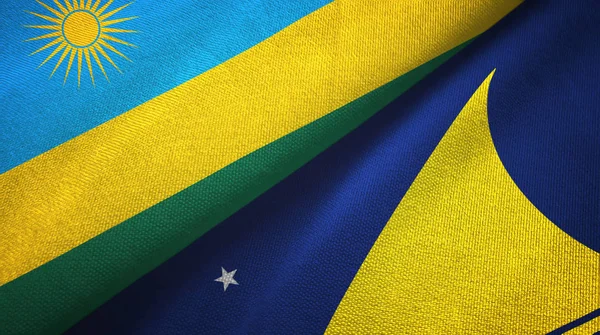 Rwanda en Tokelau twee vlaggen textiel doek, stof textuur — Stockfoto