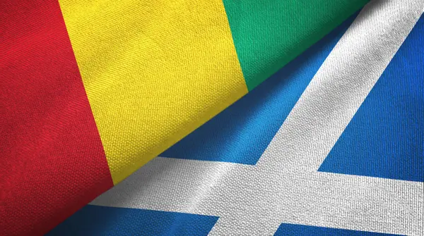 Guinea és Skócia két zászló textilszövet, szövet textúra — Stock Fotó