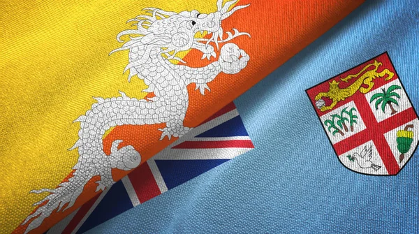 Бутан и Фиджи два флага текстильная ткань, текстура ткани — стоковое фото