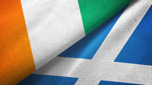 Ivory Coast Cote d'Ivoire and Scotland two flags textile cloth, fabric texture — Stock Photo, Image