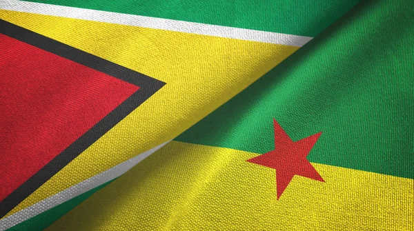 Guyana en Frans Guyana twee vlaggen textiel doek, stof textuur — Stockfoto