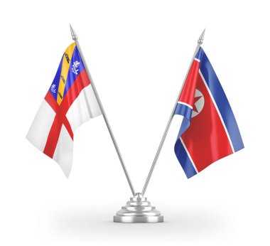 North Korea and Herm table flags isolated on white 3D rendering