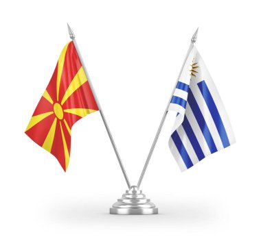 Uruguay ve Kuzey Makedonya masa bayrakları beyaz zemin üzerinde izole edilmiş 3D görüntüleme