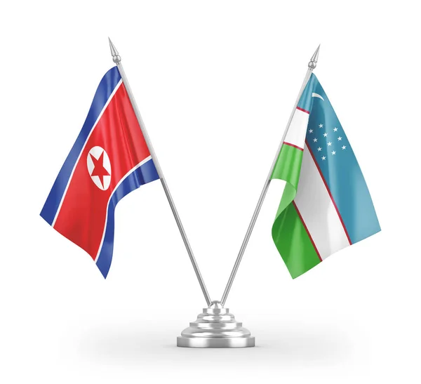 Ουζμπεκιστάν Και Βόρεια Κορέα Σημαίες Τραπέζι Απομονώνονται Λευκό Φόντο Απόδοση — Φωτογραφία Αρχείου