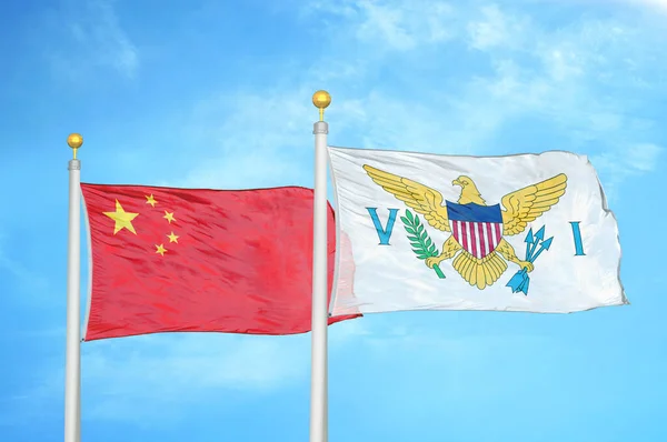China and Virgin Islands United States two flags on flagpoles and blue cloudy sky background
