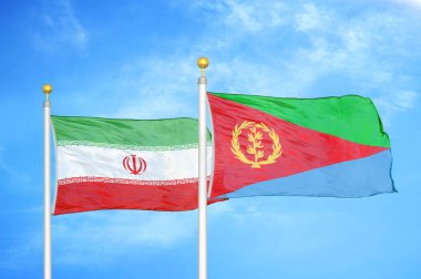 İran ve Eritre bayrak direkleri ve mavi bulutlu arka planda iki bayrak