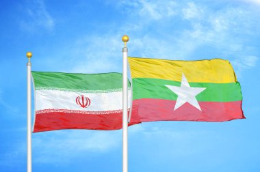 İran ve Myanmar bayrak direkleri ve mavi bulutlu arka planda iki bayrak