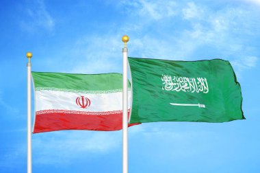 İran ve Suudi Arabistan bayrak direkleri ve mavi bulutlu arka planda iki bayrak