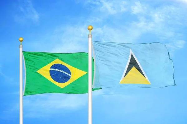 ブラジルとセントルシアの旗竿と青空の背景に2つの旗 — ストック写真