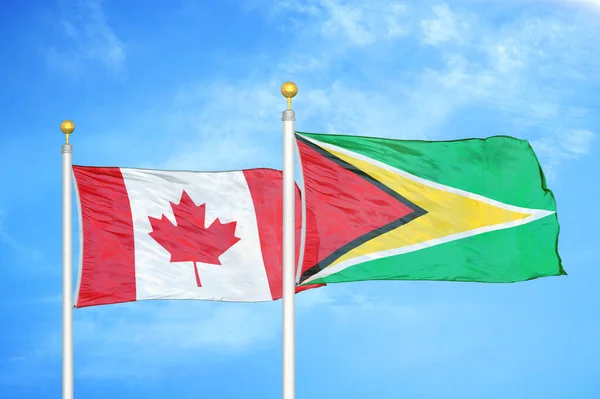 Canada Guyana Due Bandiere Pennoni Cielo Azzurro Nuvoloso Sfondo — Foto Stock