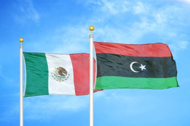 Meksika ve Libya bayrak direkleri ve mavi bulutlu arka planda iki bayrak