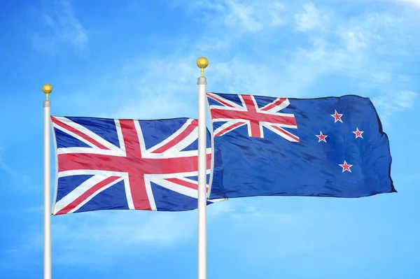 United Kingdom New Zealand Two Flags Flagpoles Blue Cloudy Sky — Stock Photo, Image