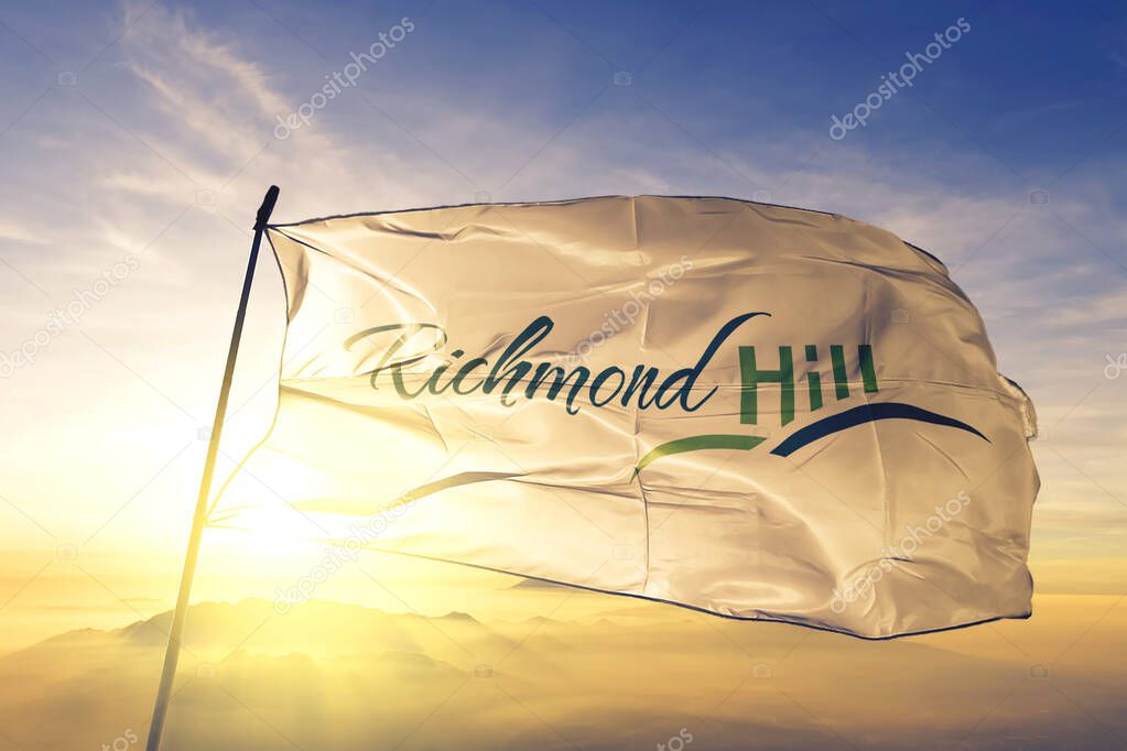 Richmond Hill of Ontario of Canada flag textile cloth fabric waving on the top sunrise mist fog