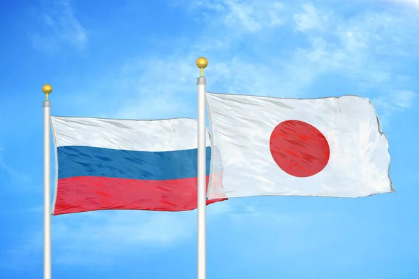 Russia Japan Two Flags Flagpoles Blue Cloudy Sky Background — Stock Photo, Image