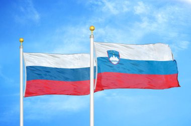 Rusya ve Slovenya bayrak direkleri ve mavi bulutlu arka planda iki bayrak