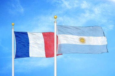 Fransa ve Arjantin bayrak direkleri üzerinde iki bayrak ve mavi bulutlu arka plan