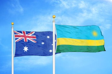 Avustralya ve Ruanda bayrak direkleri ve mavi bulutlu arka planda iki bayrak