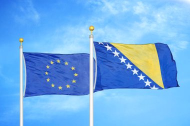 Avrupa Birliği ve Bosna-Hersek bayrak direkleri ve mavi bulutlu arka plan üzerinde iki bayrak