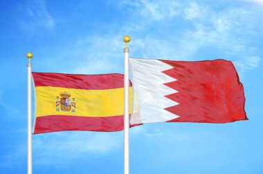 İspanya ve Bahreyn bayrak direkleri üzerinde iki bayrak ve mavi bulutlu arka plan