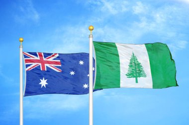 Avustralya ve Norfolk Adası bayrak direkleri ve mavi bulutlu arka planda iki bayrak