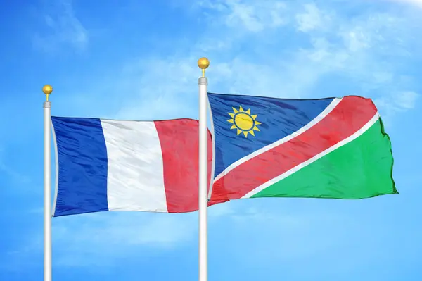 Frankrijk Namibië Twee Vlaggen Vlaggenmasten Blauwe Bewolkte Lucht Achtergrond — Stockfoto