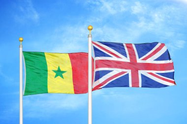 Senegal ve Birleşik Krallık bayrak direkleri ve mavi bulutlu arka planda iki bayrak
