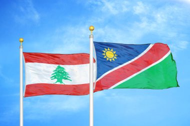 Lübnan ve Namibya bayrak direkleri üzerinde iki bayrak ve mavi bulutlu arka plan