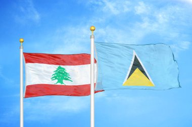Lübnan ve Saint Lucia bayrak direkleri ve mavi bulutlu arka planda iki bayrak