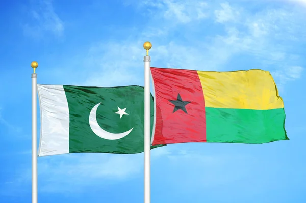 Pakistan Guinea Bissau Two Flags Flagpoles Blue Cloudy Sky Background — Stock Photo, Image