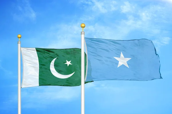 Pákistán Somálsko Dvě Vlajky Vlajkových Stožárech Modrá Oblačná Obloha Pozadí — Stock fotografie