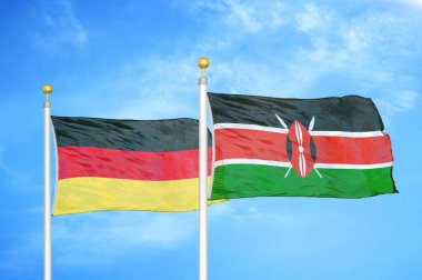 Almanya ve Kenya bayrak direkleri ve mavi bulutlu arka planda iki bayrak