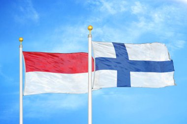 Endonezya ve Finlandiya bayrak direkleri ve mavi bulutlu arka planda iki bayrak