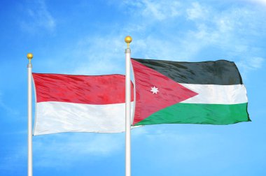 Endonezya ve Ürdün bayrak direkleri üzerinde iki bayrak ve mavi bulutlu arka plan